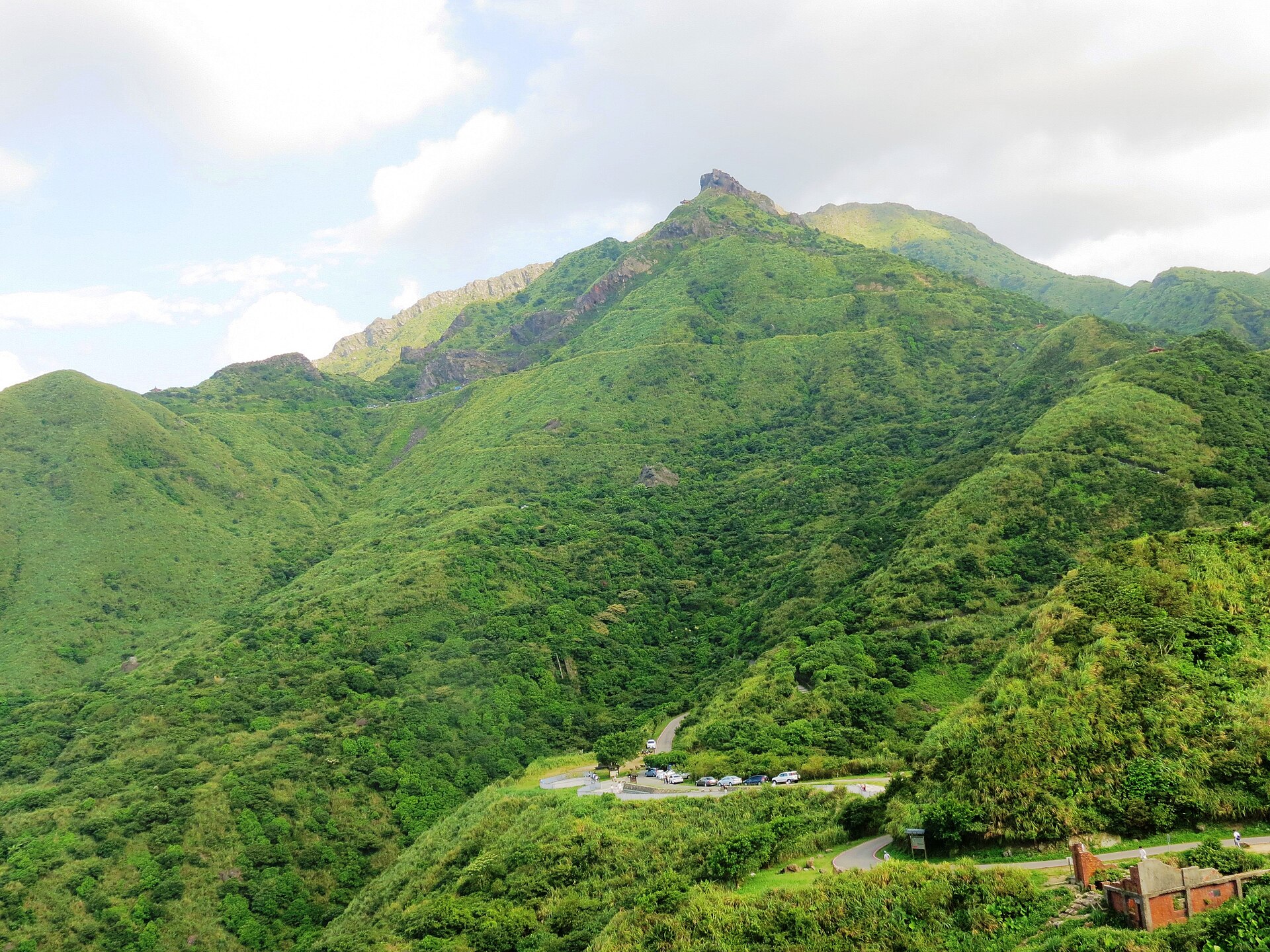 Teapot Mountain rising above the green ridges